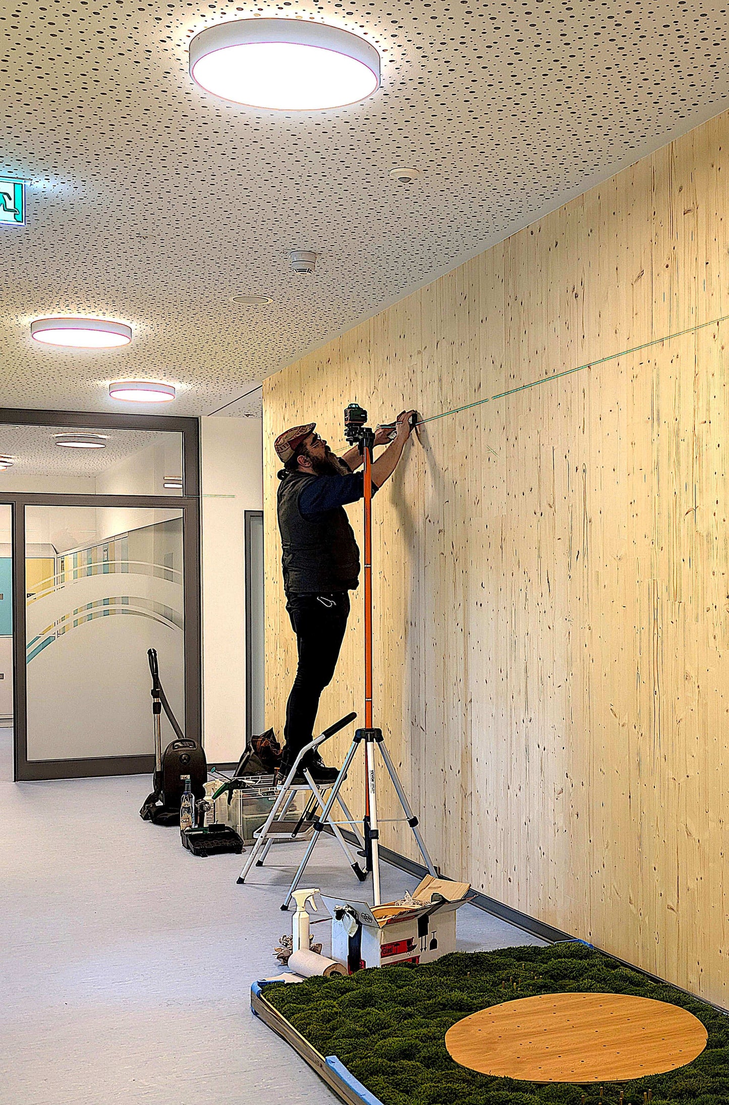 Ein Mann bei der Montage eines Moosbildes