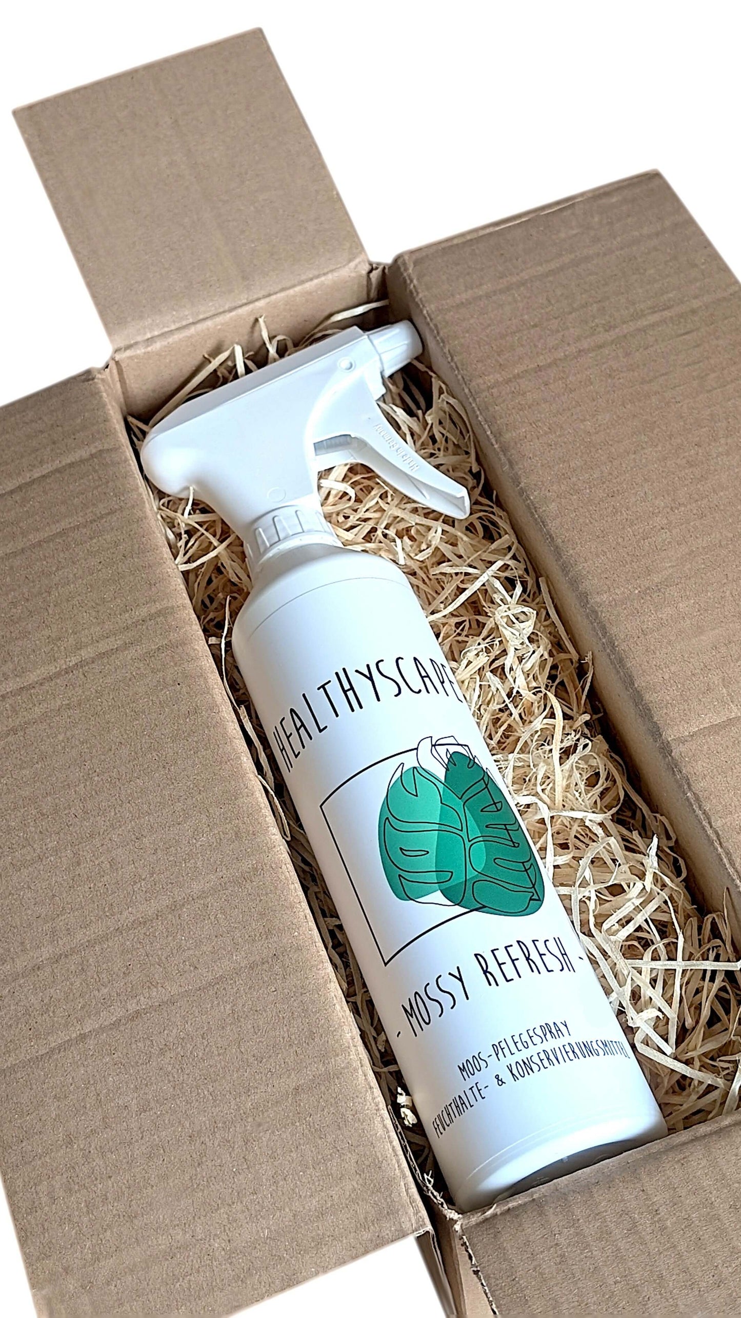 Mossy Refresh natural care spray for preserved moss artworks in a cardboard box with protective filling.