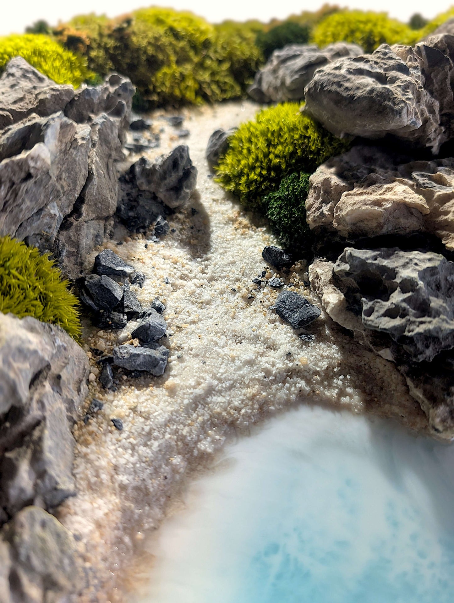 Detail of 'Autumn Coast' artwork featuring rocks and moss in a serene coastal landscape with epoxy resin.