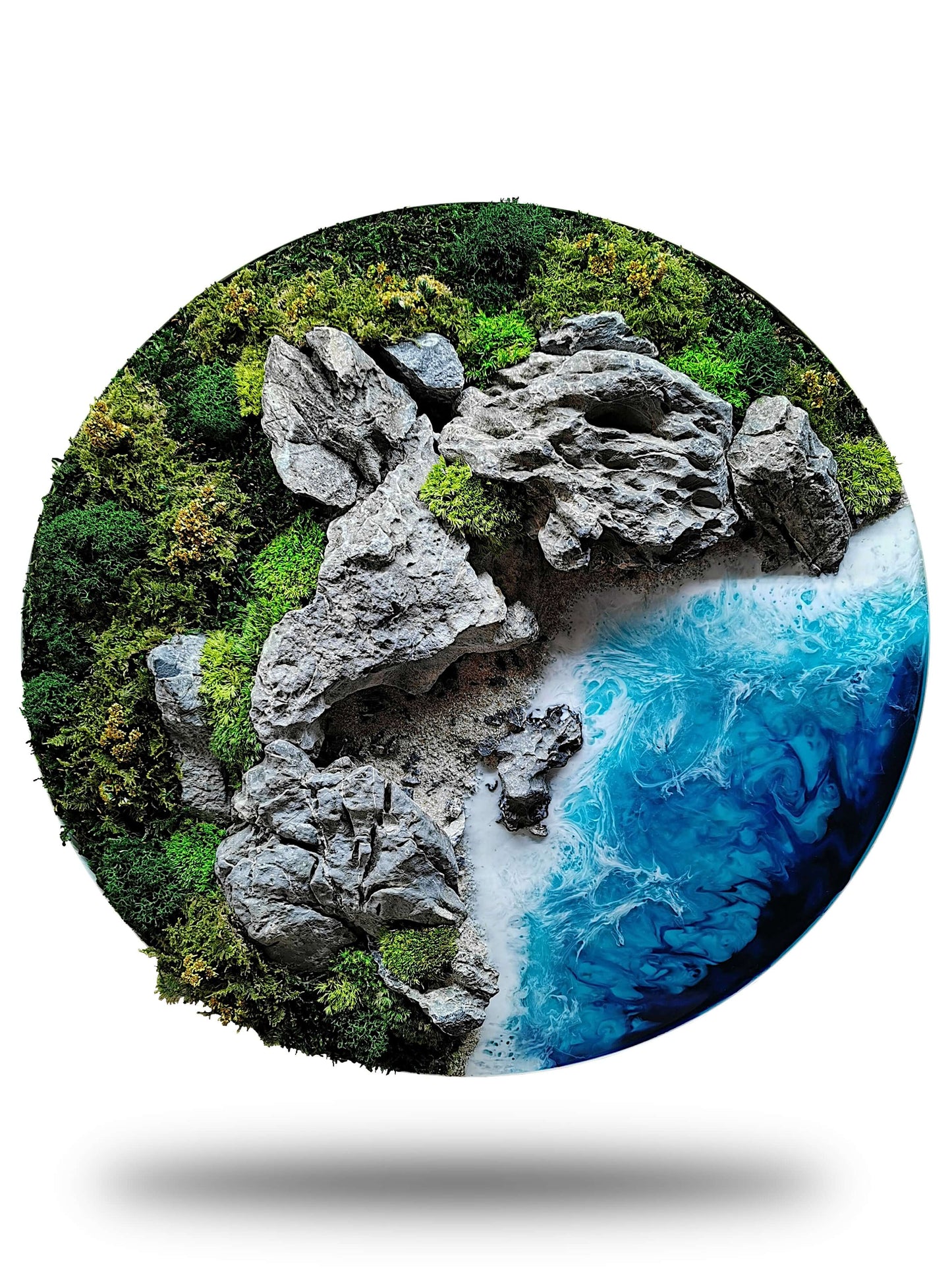 Circle artwork of a coastal landscape with rocks, moss, and blue ocean waves in a unique diorama style.