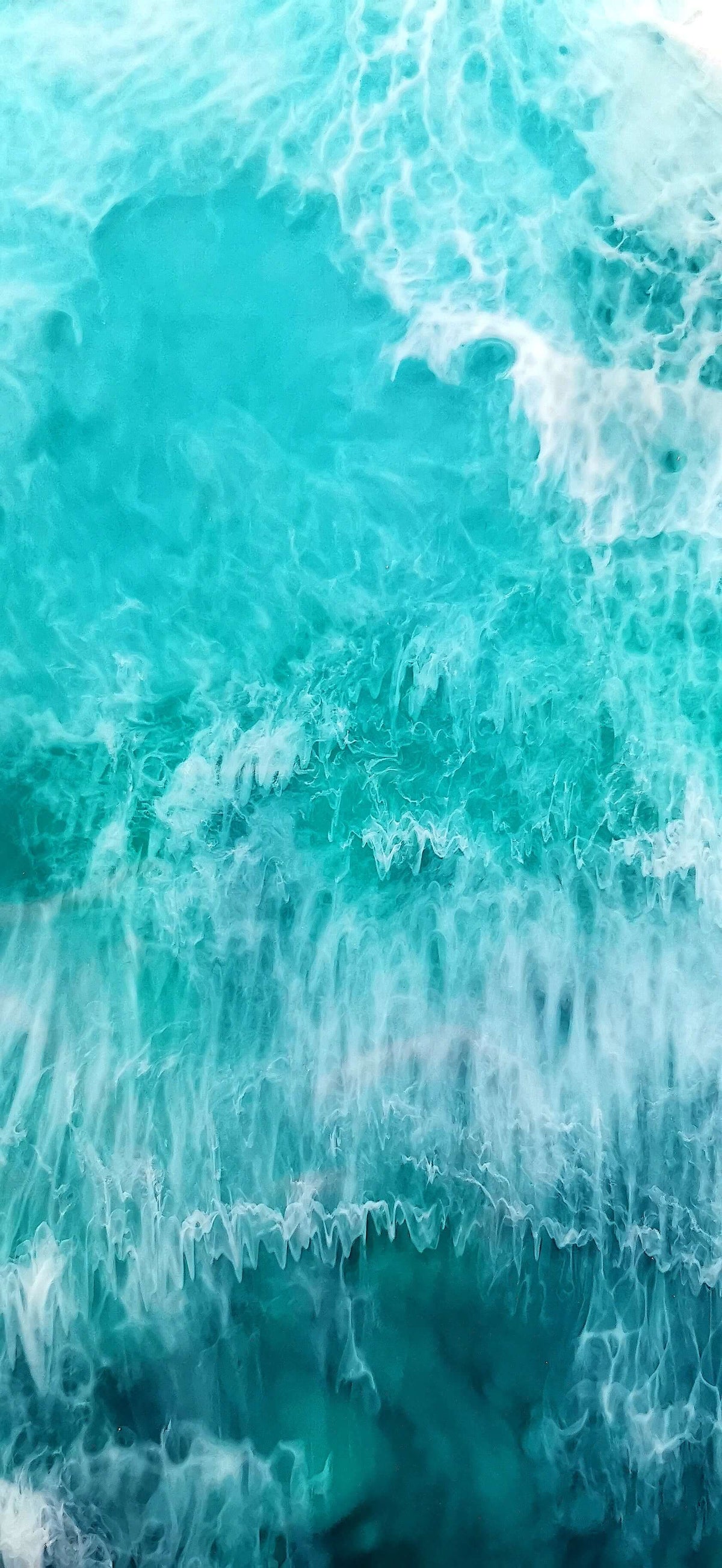 Ocean waves in shades of turquoise and blue, creating a serene and calming atmosphere perfect for wall art.