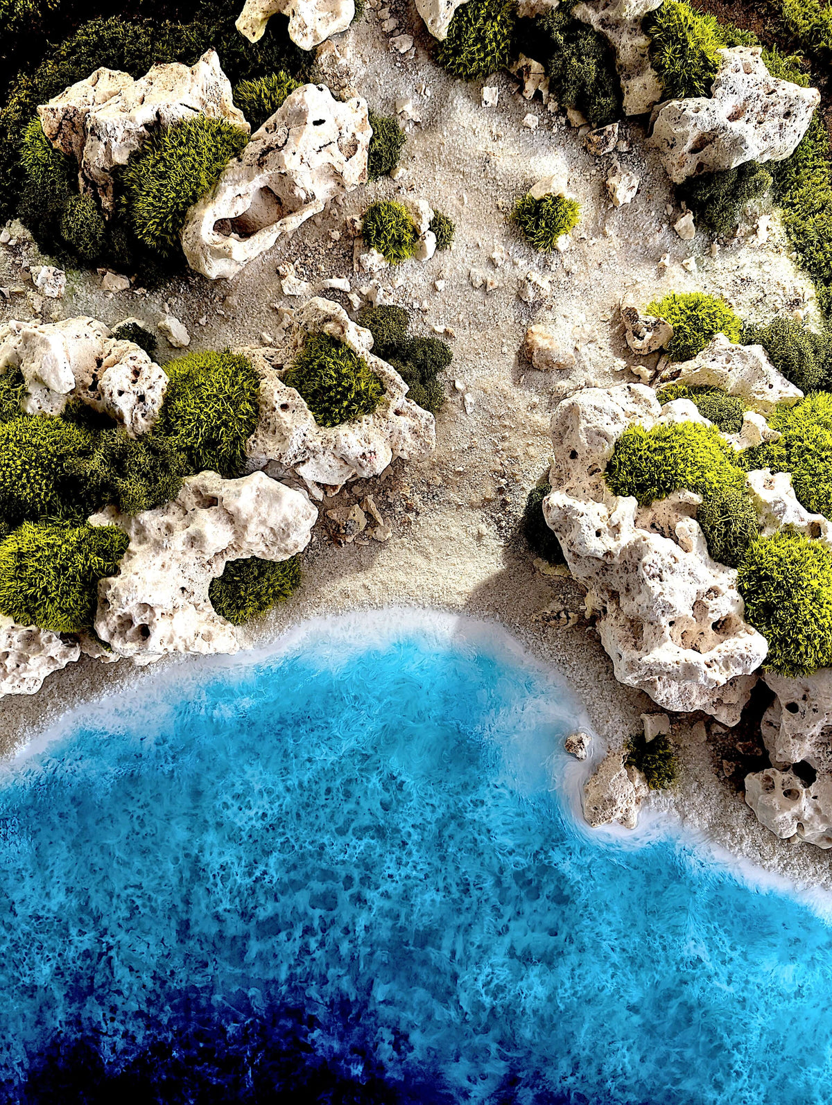 Detailaufnahme des Wandbilds "Ocean Coast", zeigt Küstenlandschaft mit klarem Wasser und Naturmaterialien.